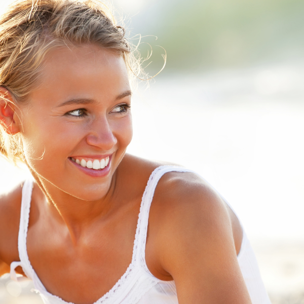 woman smiling happy sunshine teeth whitening dental toothbrush flynns pharmacy